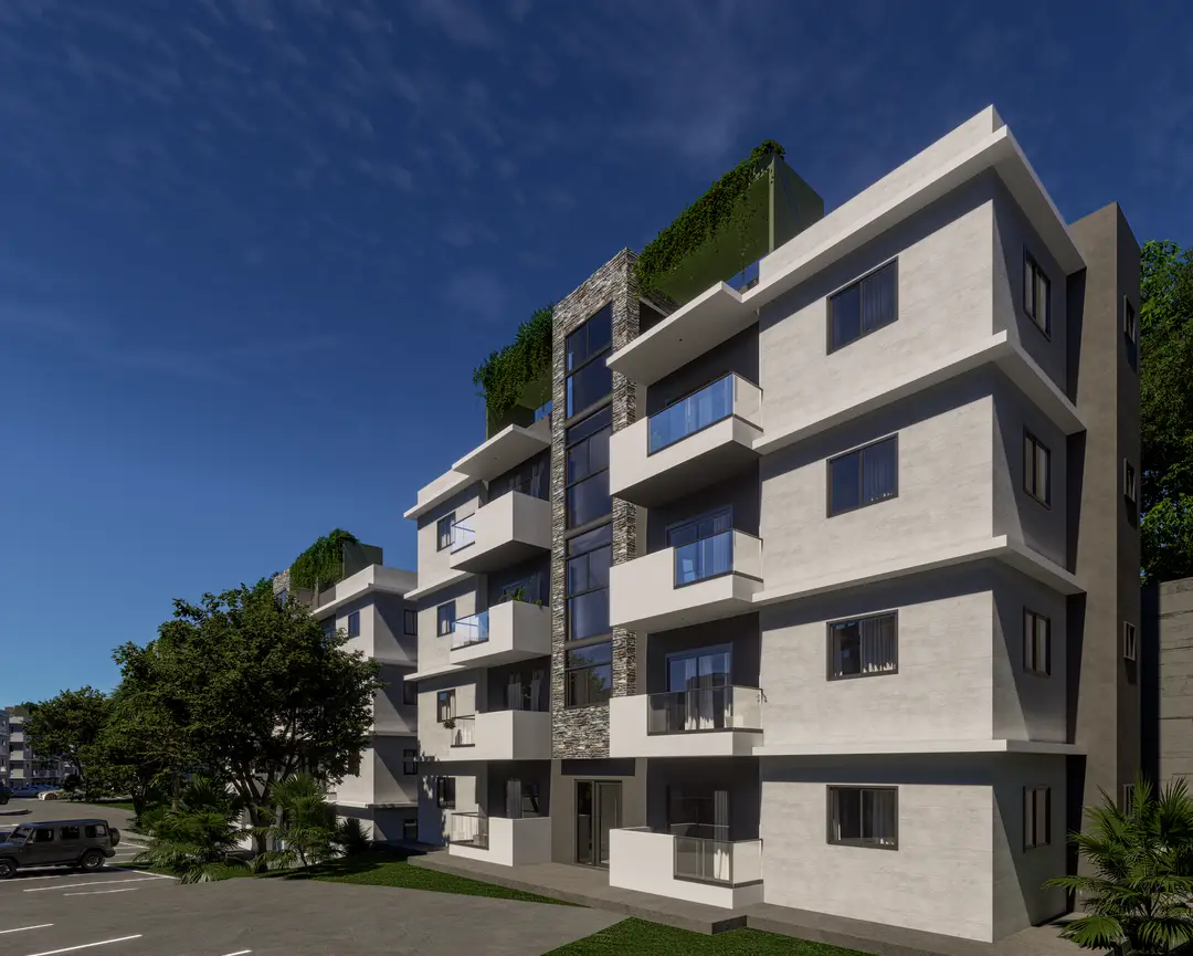 Fachada de Embassy Gardens con volúmenes blancos, balcones de cristal y franja de piedra